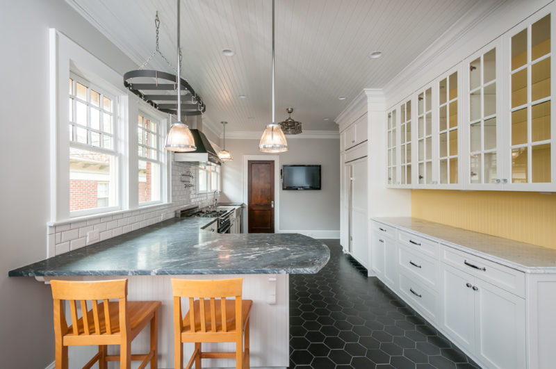 Craftsman kitchen with tongue-and-groove ceiling and bead board, with pops of yellow