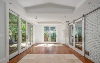 Modern sunroom with hardwood floors and sliding glass doors