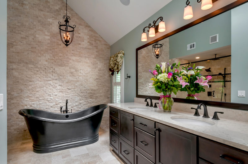Traditional master bathroom with stacked stone wall