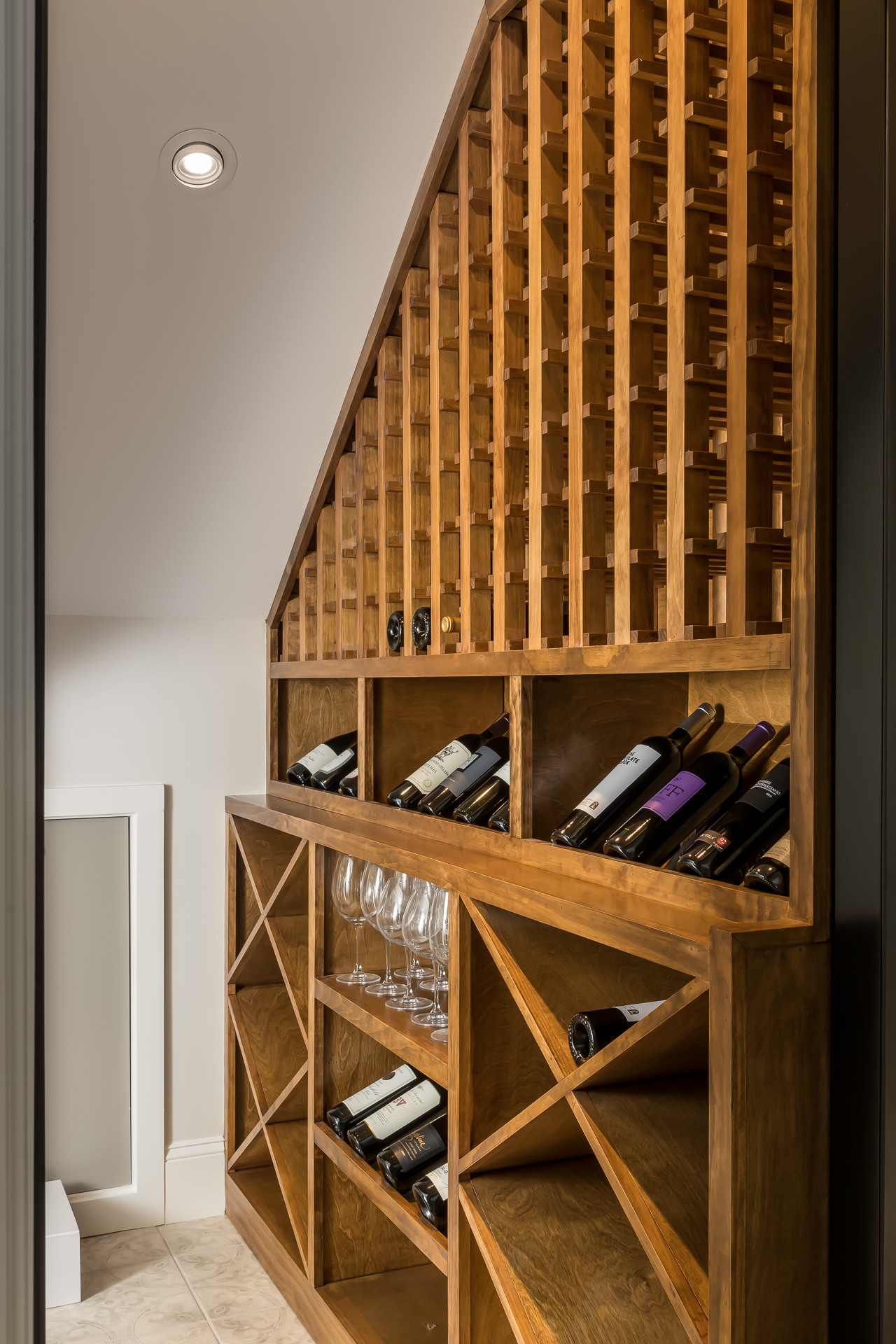 Basement renovation wine cellar under stairs
