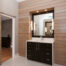 Contemporary primary bathroom with vanity and wood-paneled walls and door