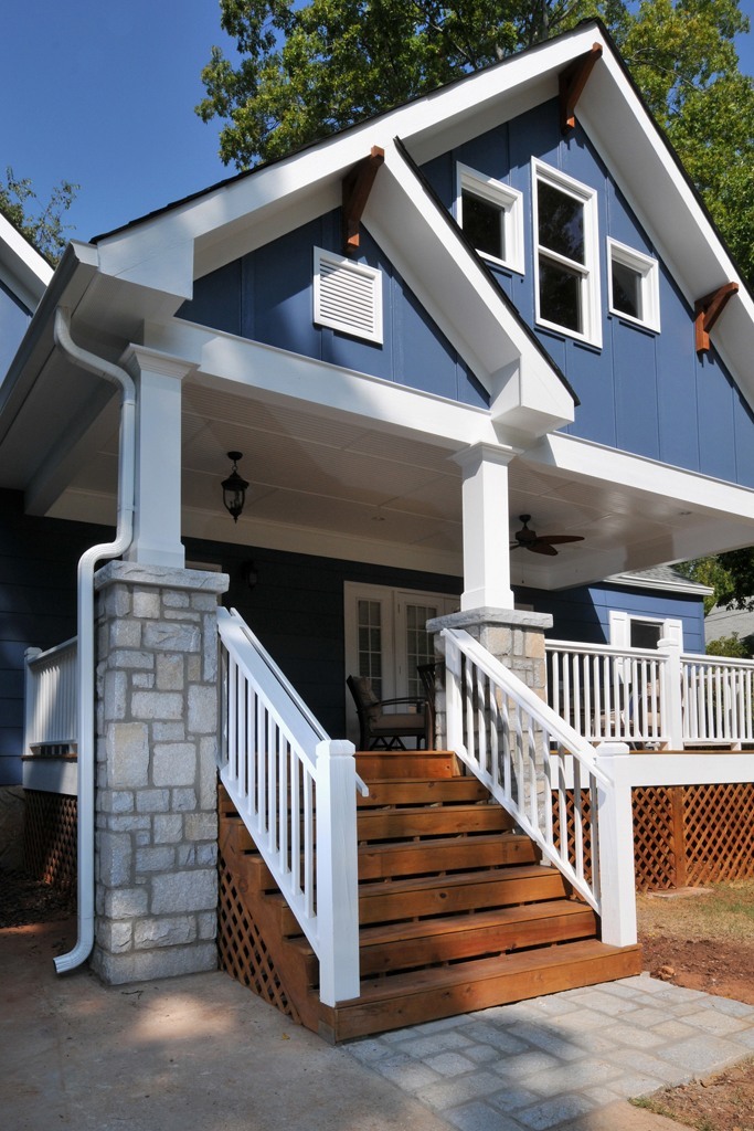 Craftsman front porch with brick, wood columns, and wood ceiling