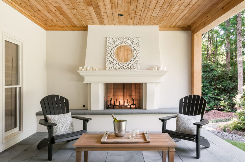 An exquisite patio adorned with a captivating fireplace, enhancing the beauty of the outdoor space.