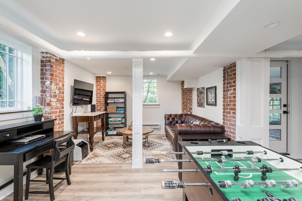 basement with foosball, piano, and an entertainment area