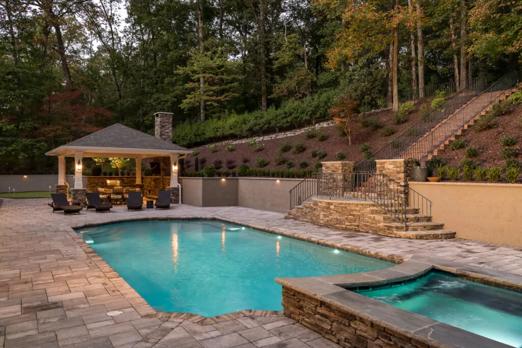 A backyard in ground pool with a cazebo and great seating