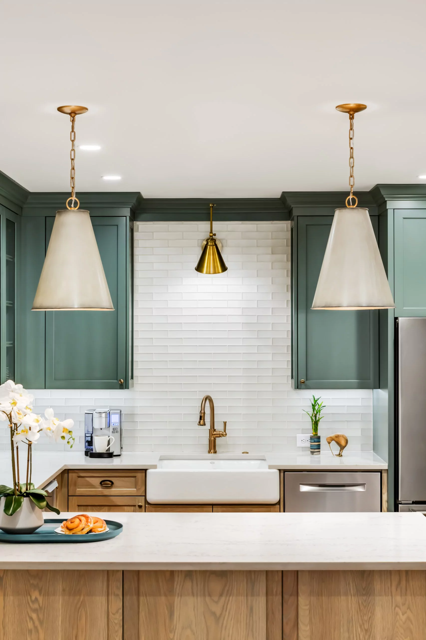 A kitchen design displaying vibrant green cabinets complemented by pristine white counter tops.
