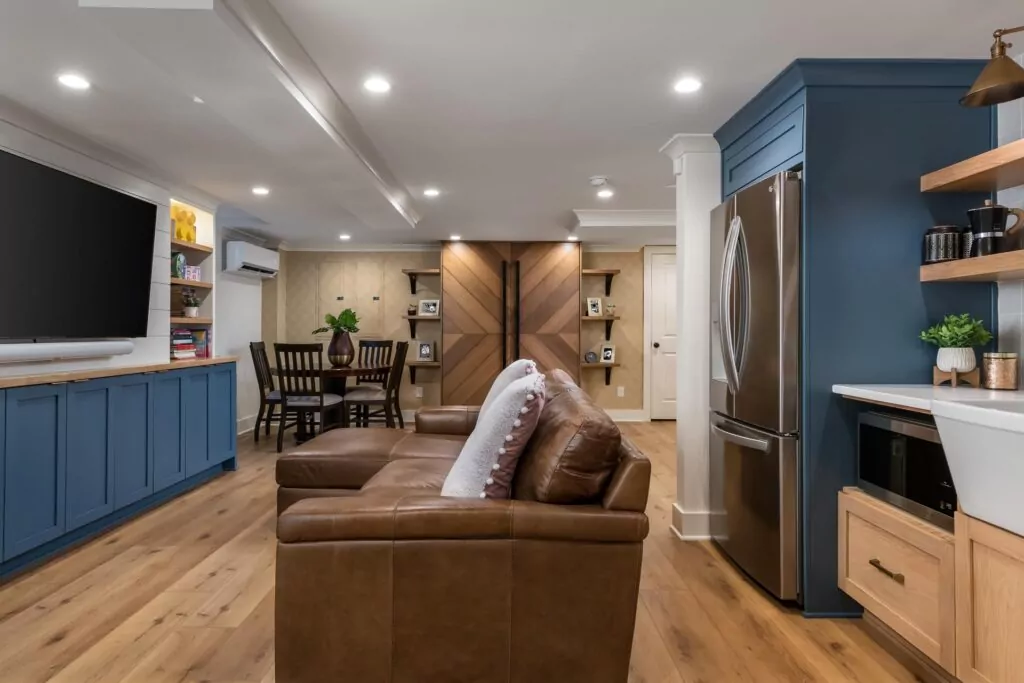 basement remodel with leather sofa and blue built-ins