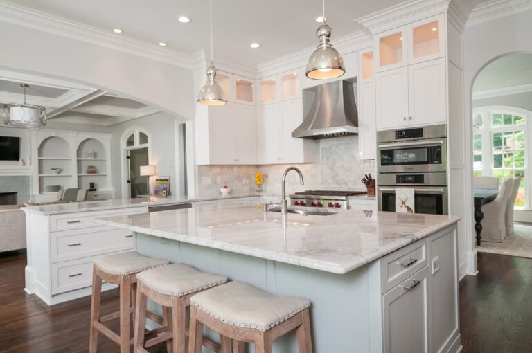 French country inspired kitchen with light cabinets and island