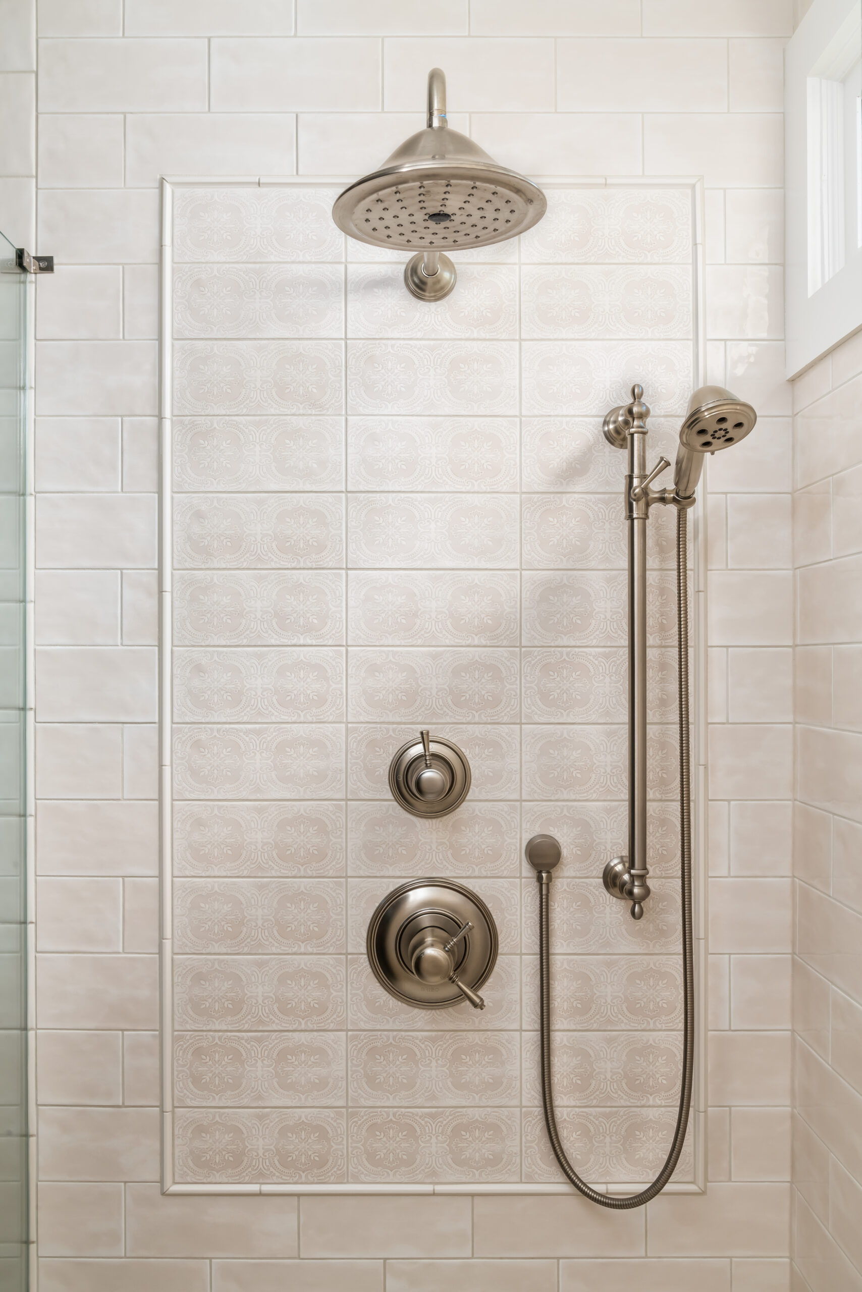 faucet wall in shower, patterned tile