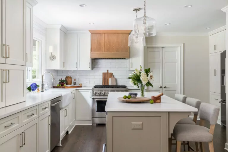 traditional kitchen remodel with large center island, white cabinets, and custom stove hood