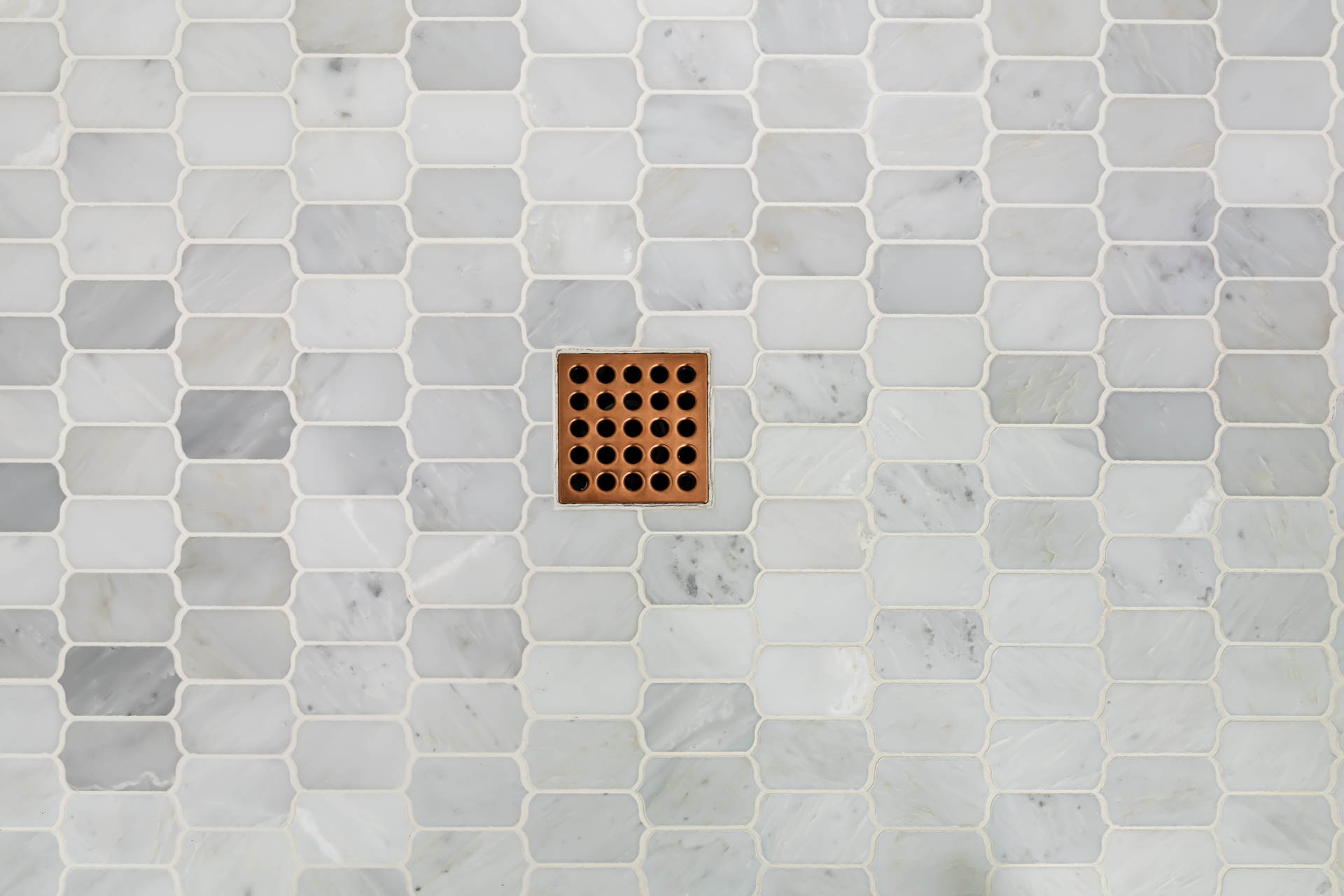 marble mosaic shower floor and copper shower drain