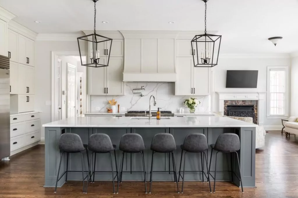 large modern kitchen with white cabinets and grey granite island
