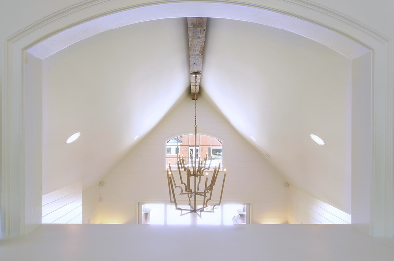 a unique chandelier hanging from the ceiling in a white room