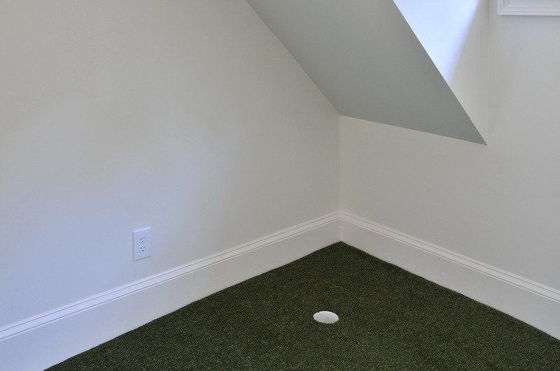 A practice golf room with built in golf holes