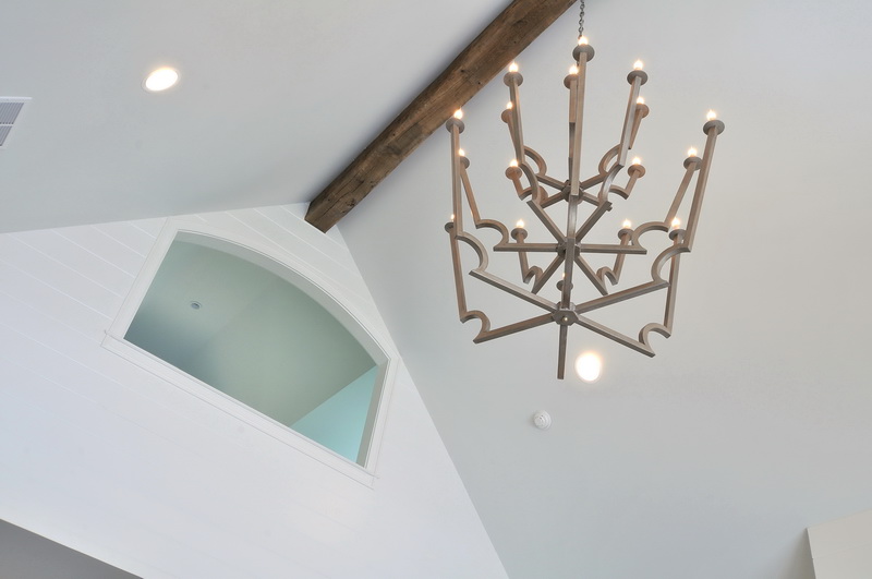 a unique chandelier hanging from the ceiling in a living room