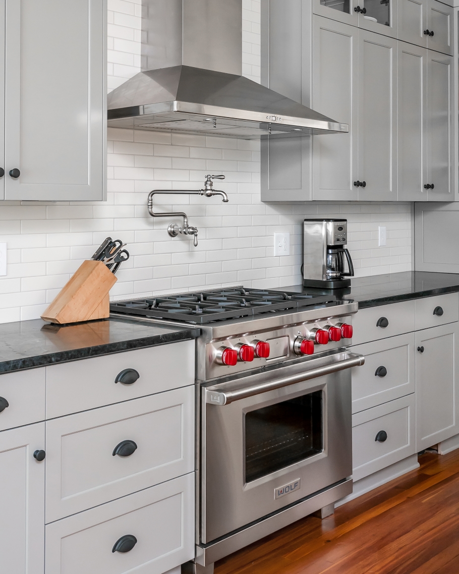 Stainless steel chef-inspired gas range stove in newly renovated kitchen