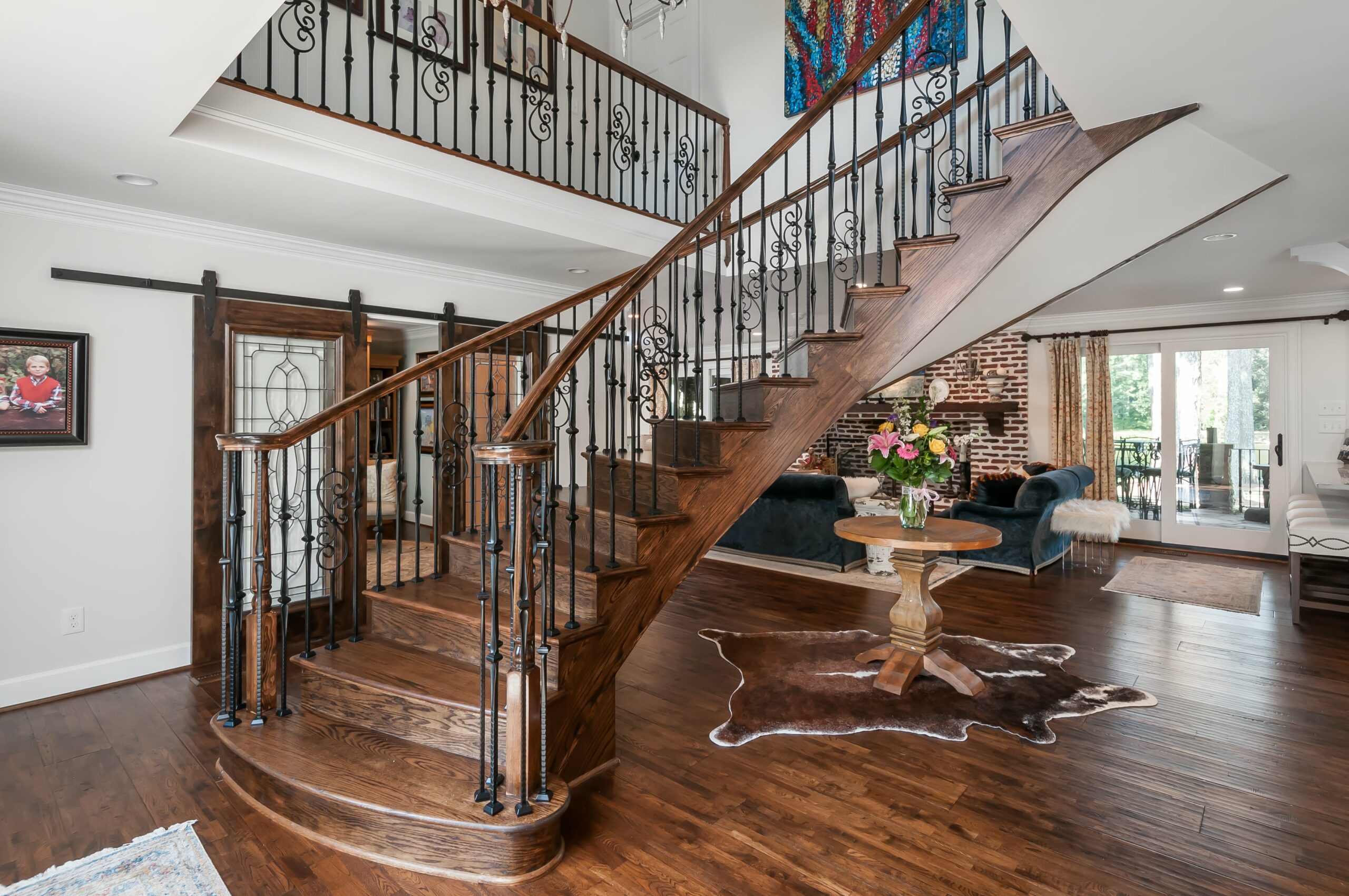 French style wooden spiral staircase in entry way of home