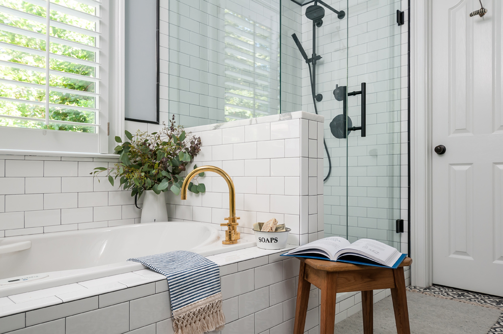 A beautifully designed eclectic bathroom featuring a tub, shower, and sink.