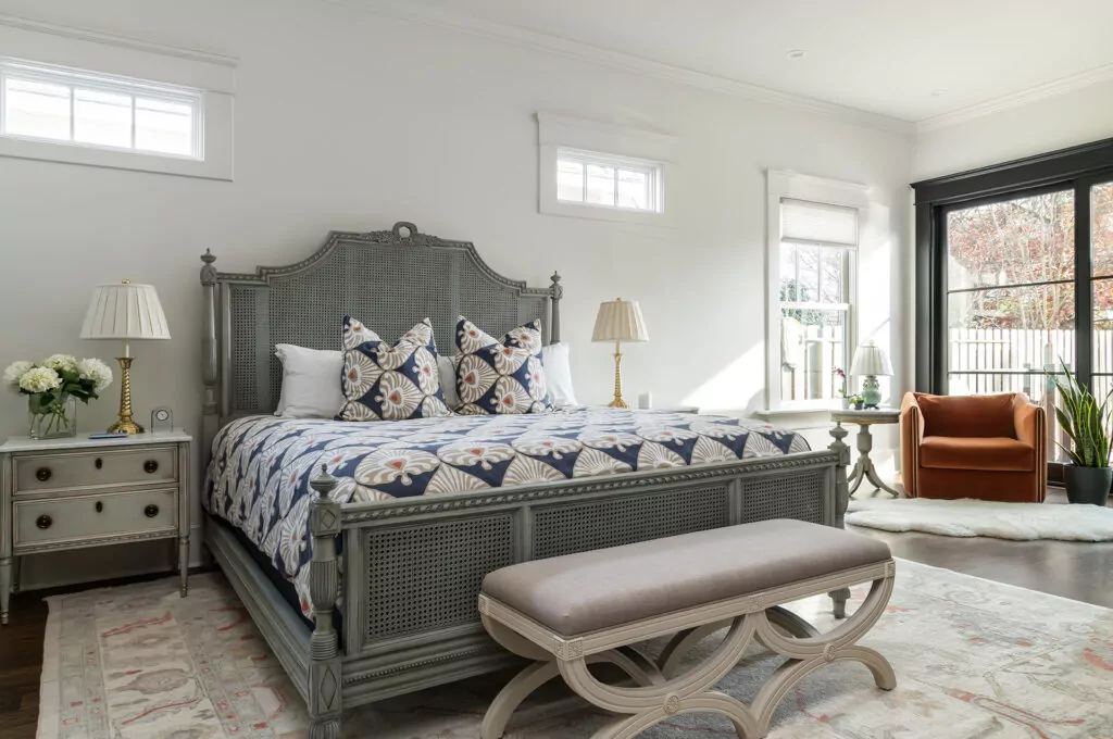 A newly remodeled bedroom with large bed and large window
