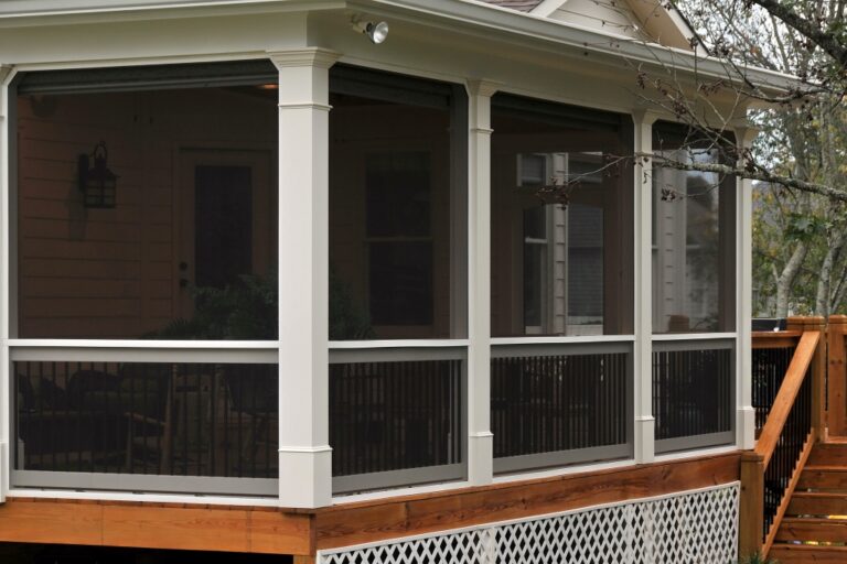 a screened porch with railings and stairs