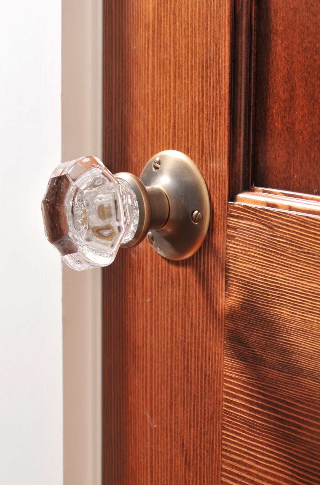 Closeup of glass doorknob on wooden door