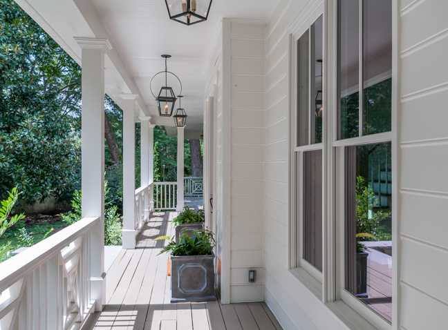 a porch with white walls and wooden floors