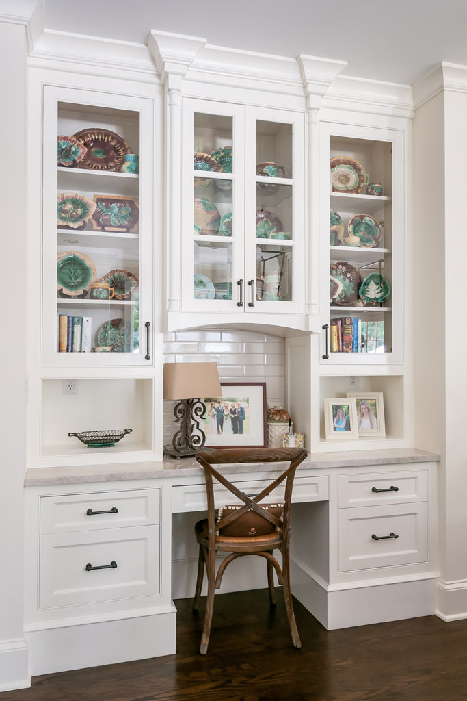 a white cabinet with glass doors and shelves