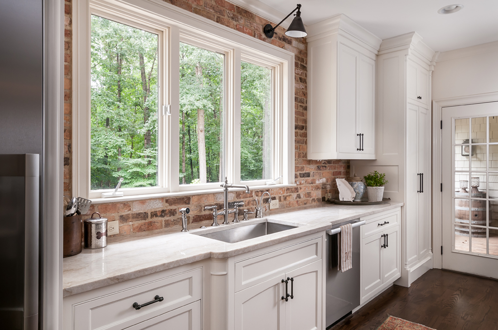 kitchen upgrade with large window, sink, and white counters
