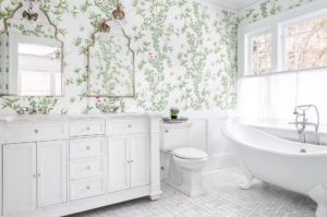Vintage charm bathroom design with clawfoot tub and floral wallpaper