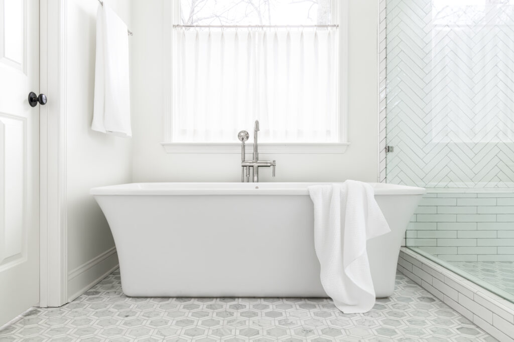a white freestanding bath tub under a window freestanding tubs versus built-in tubs
