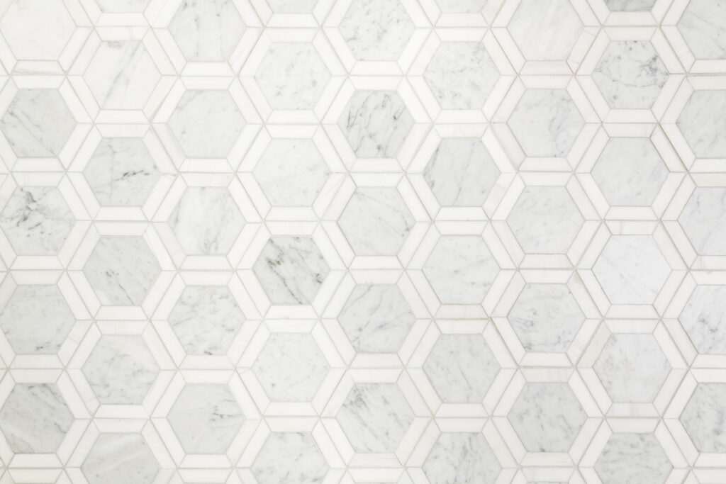 a white marble wall with hexagonal pattern