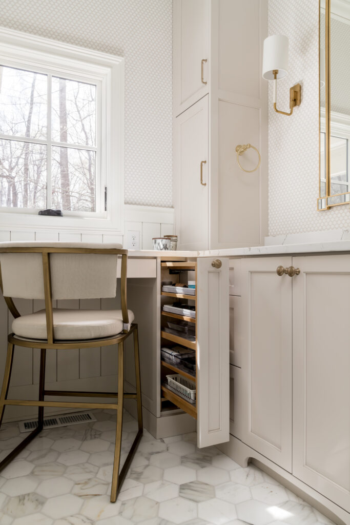 a white bathroom with a vanity and chair
