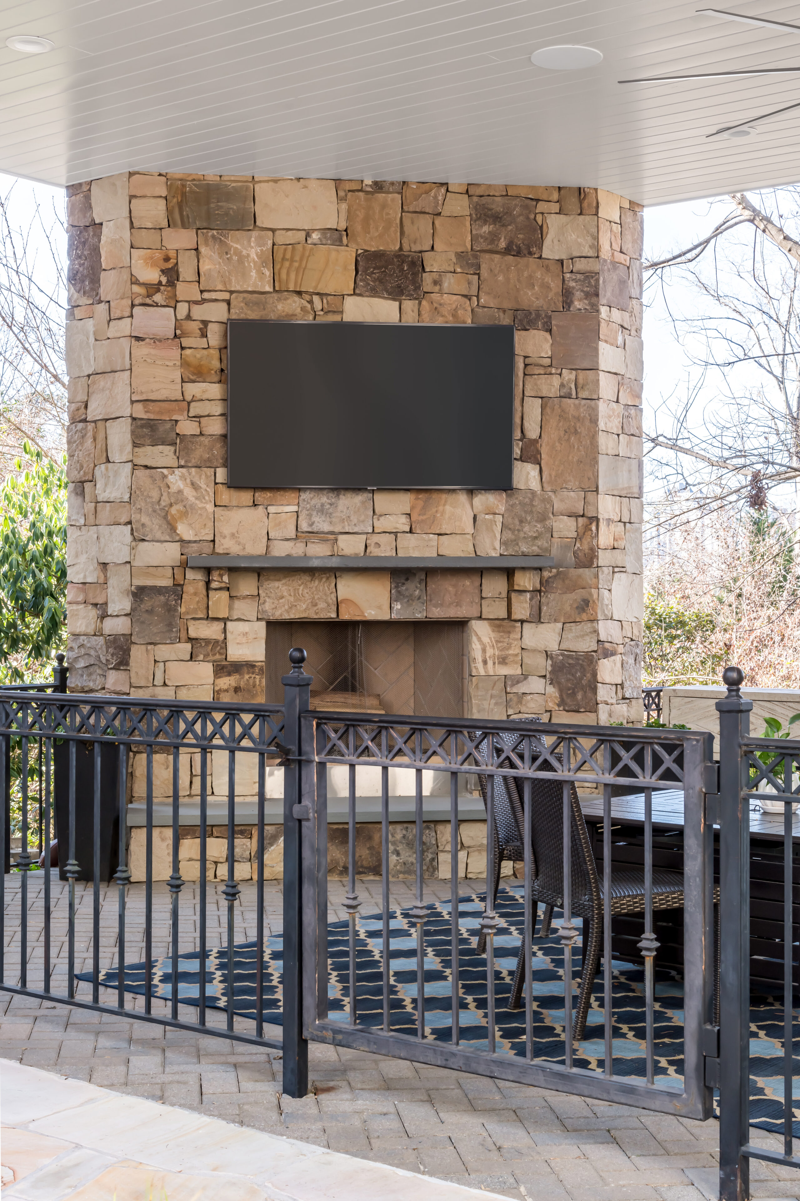 a stone fireplace with a television mounted above it