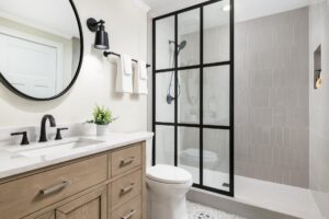 a newly remodeled bathroom with a shower, toilet and sink