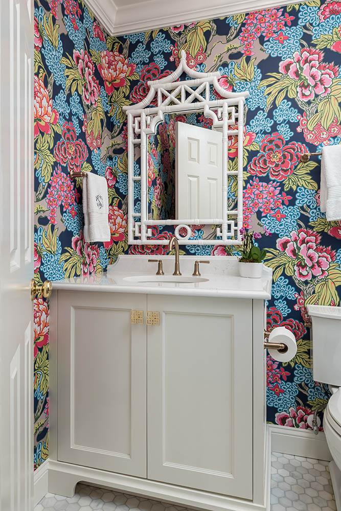 remodeled basement half-bath with floral wallpaper