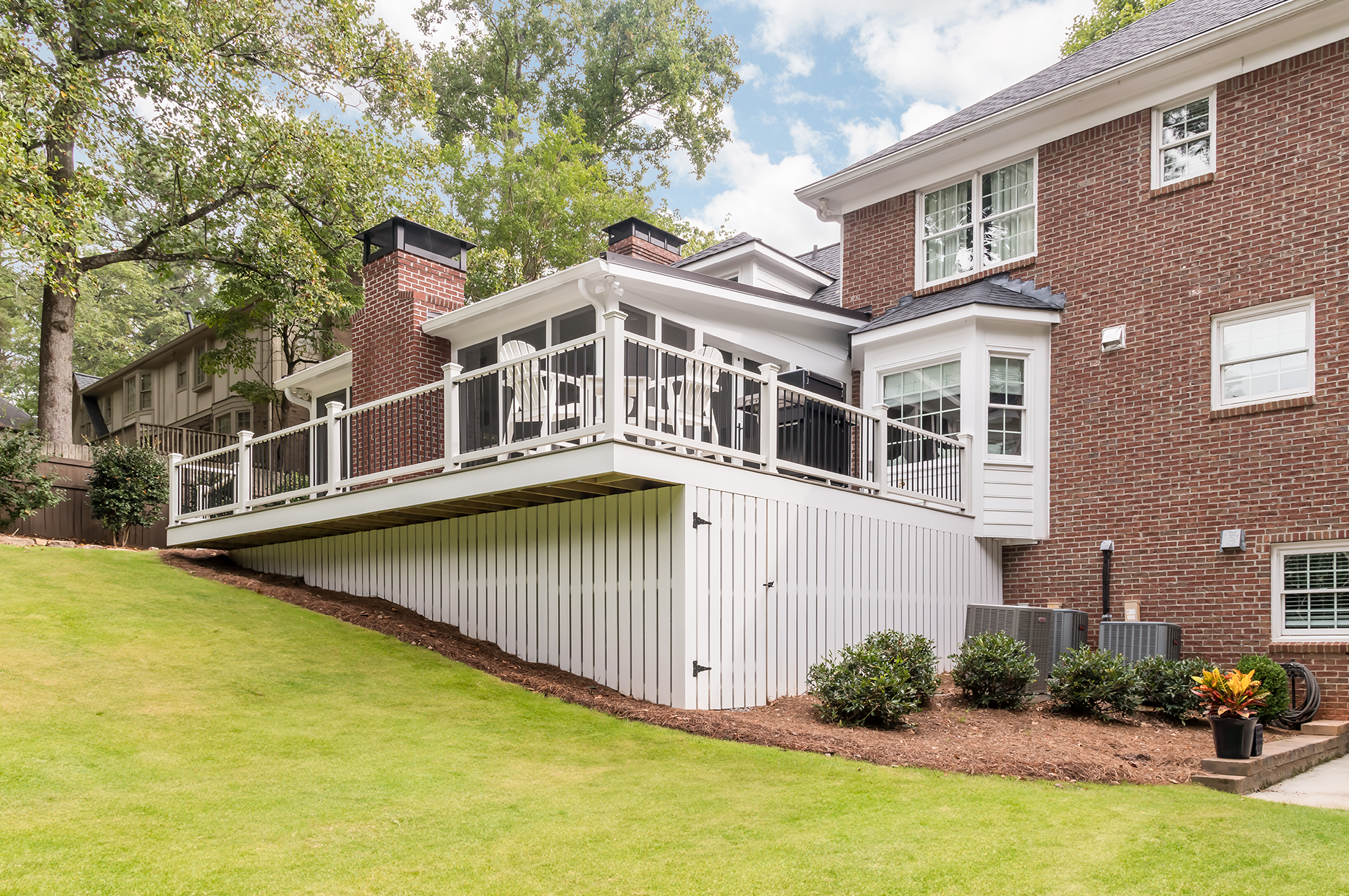 Exterior of home with a screened porch and deck