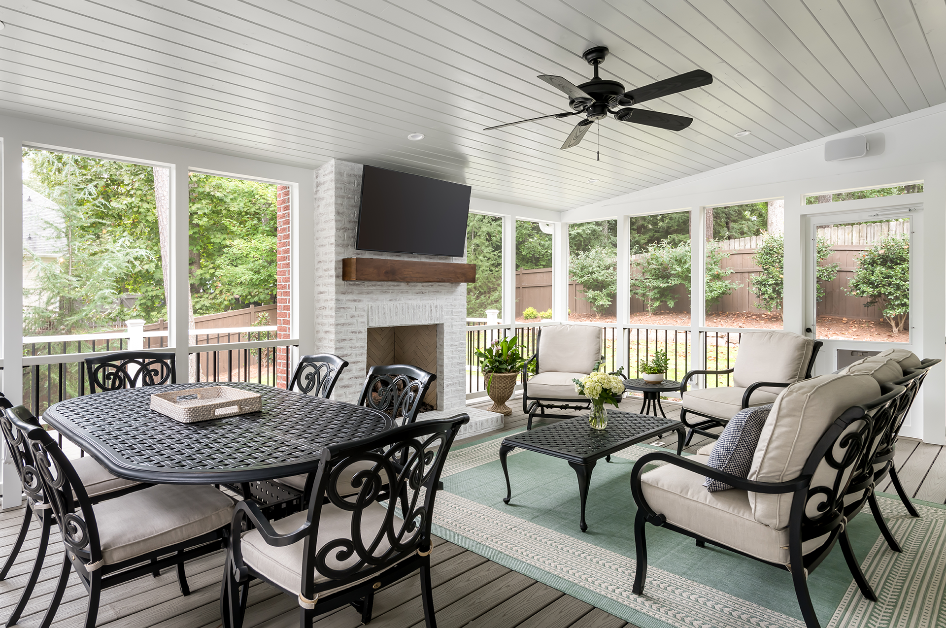 A newly remodeled screened porch with ample seating and TV