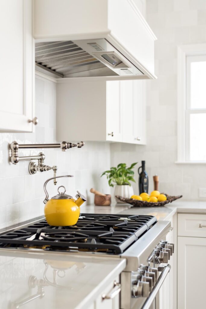 a newly remodeled kitchen with white cabinets and a yellow teapot on the stove 5 Kitchen Must-Haves for 2024