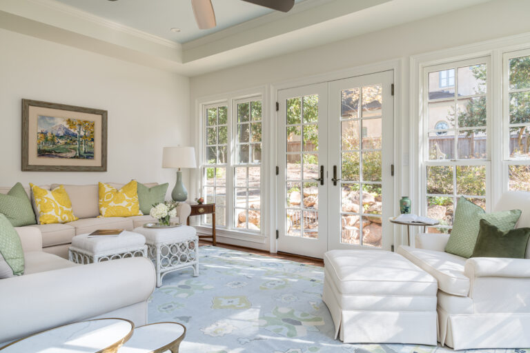 a sunroom filled with furniture and lots of windows