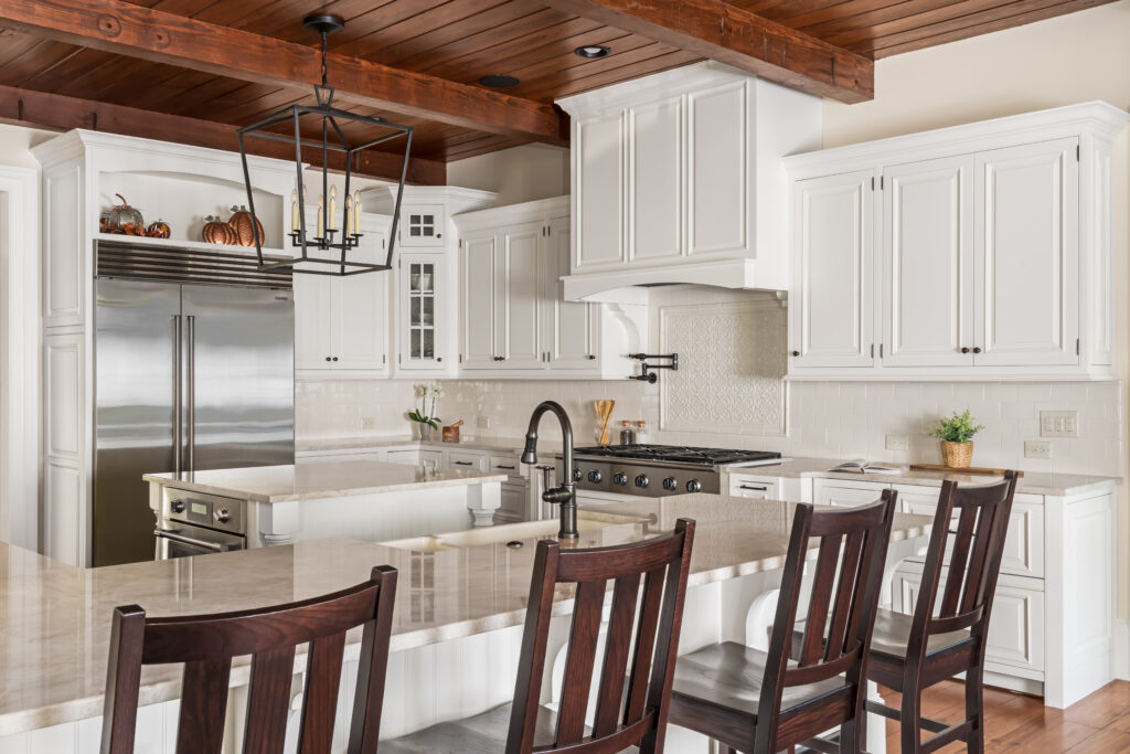 a kitchen with white cabinets and wooden floors