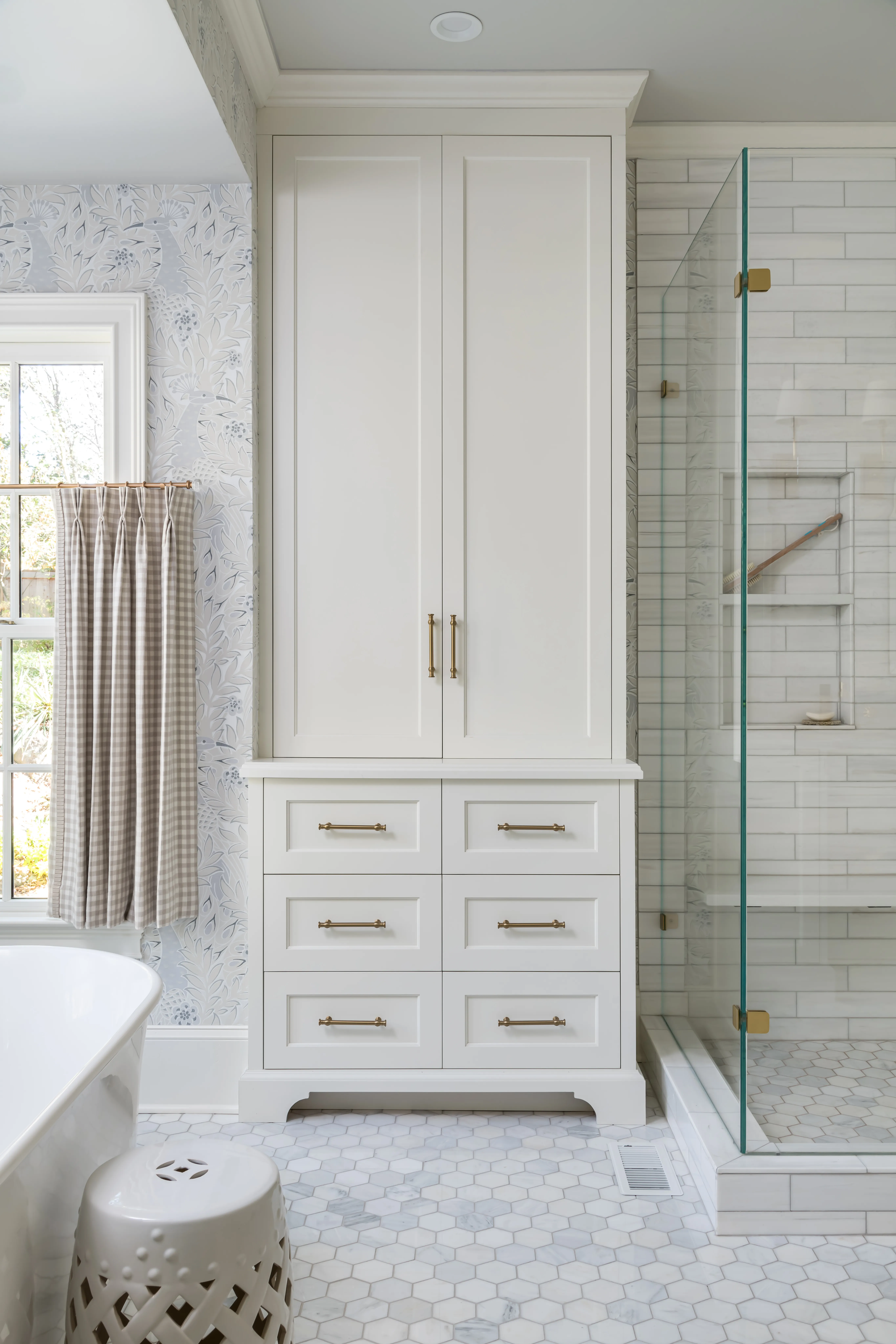 a bathroom with a white cabinet and shower