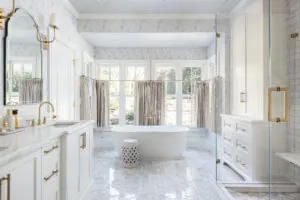 a bathroom with a tub, sink and mirror