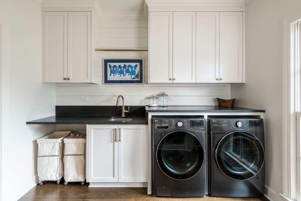 a kitchen with a washer and dryer in it