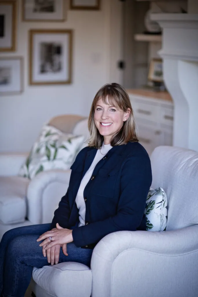 a woman sitting on a chair in a living room