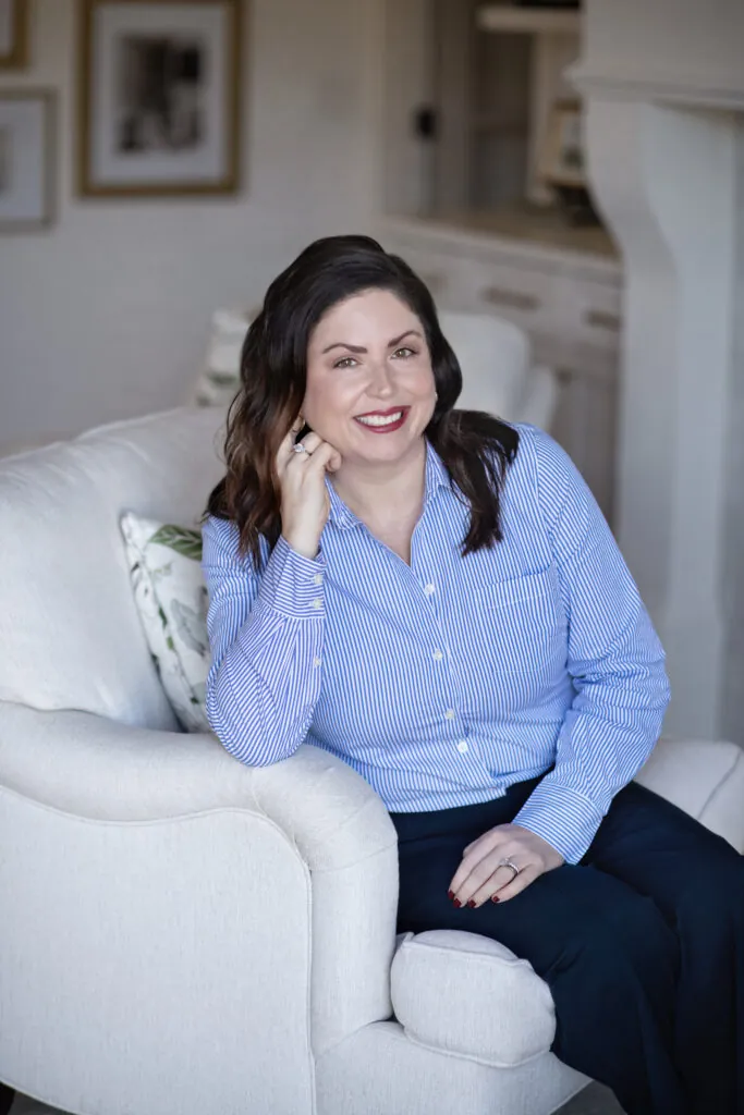 a woman sitting on a couch talking on a cell phone