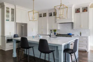 a large kitchen with white cabinets and a center island