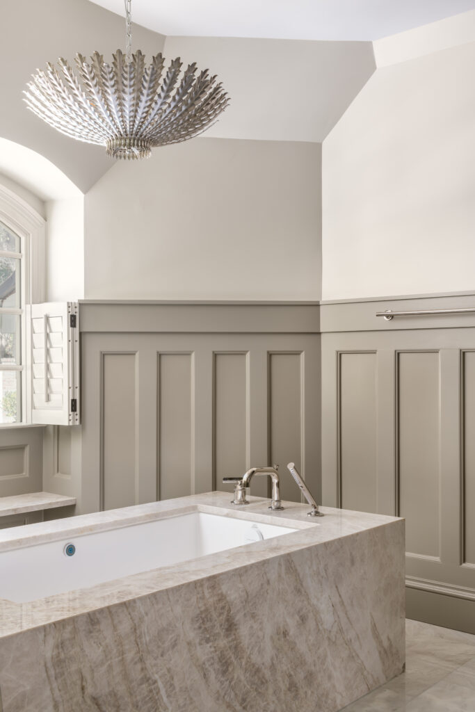 a bathroom with a large bathtub and a chandelier