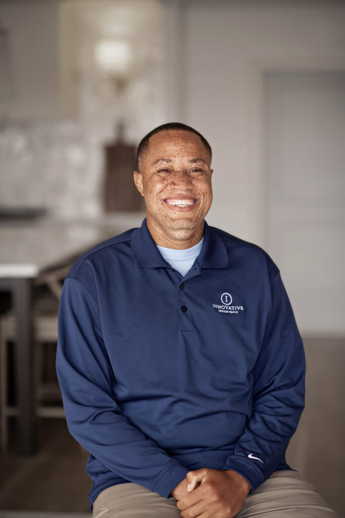a man in a blue shirt sitting on a couch