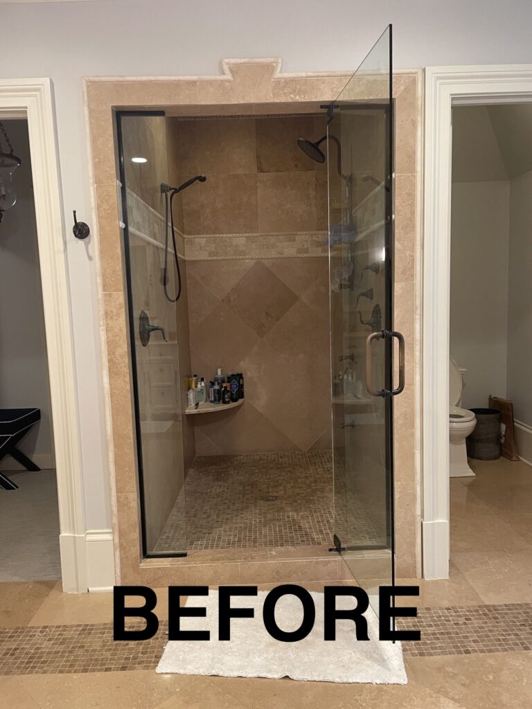a bathroom with a walk in shower next to a toilet
