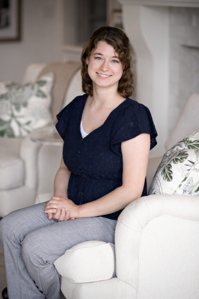 a woman sitting on a couch in a living room